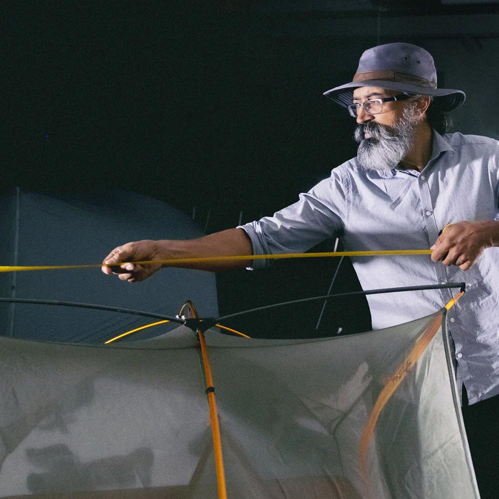 A man measuring a tent