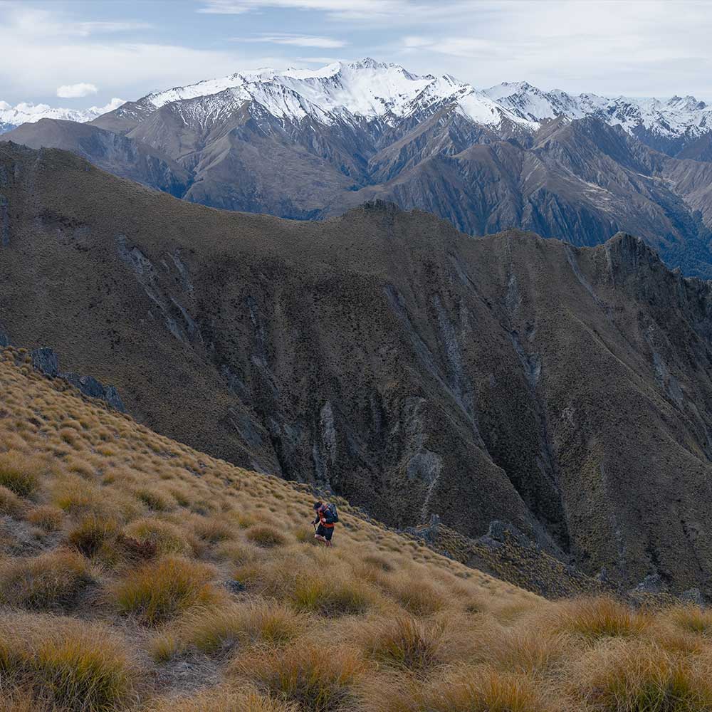 A male hiker ascending a steep incline.